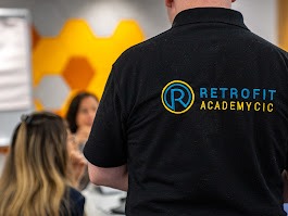 An individual wearing a black Retrofit branded polo t-shirt.