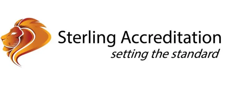 The logo of Sterling Accreditation, a 2D face of an orange lion, that has the business name reading in black text with the words "setting the standard" reading in black text below it.